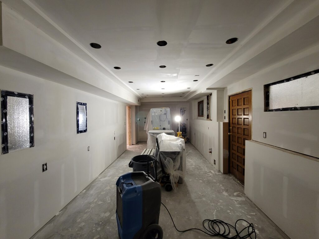 New drywall on ceilings and wall in a basement
